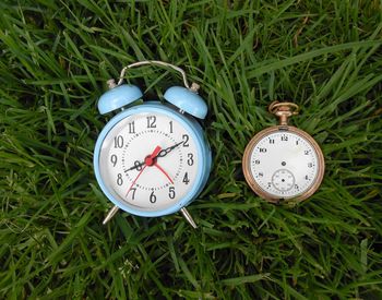 Close-up of clock on grass