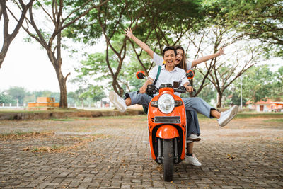 Portrait of smiling young woman riding bicycle