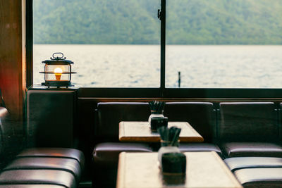 View of the water and mountain from inside a cozy lakeside restaurant