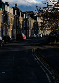Vehicles on road along buildings