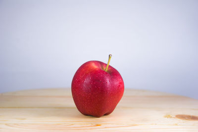 Close-up of apple on table against white background