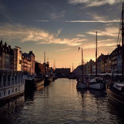 Boats in river with buildings in background