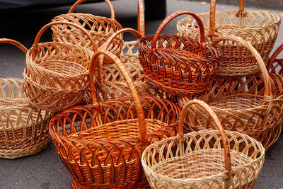 Group of empty wicker baskets for sale in a market place. heap of wicker baskets dark brown oval 