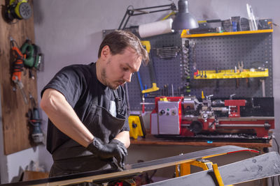 Man working on metal grate