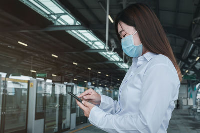 Side view of woman using mobile phone