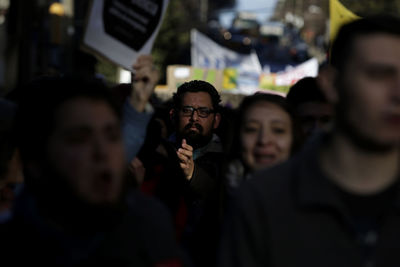 Portrait of man amidst crowd during protest