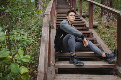 Young man sitting on staircase