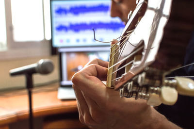 Close-up of man playing guitar