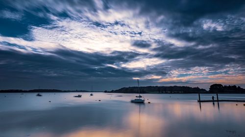 Sailboats in marina at sunset