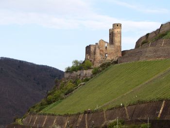 Built structure on landscape against sky