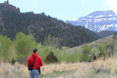 Rear view of man standing on mountain