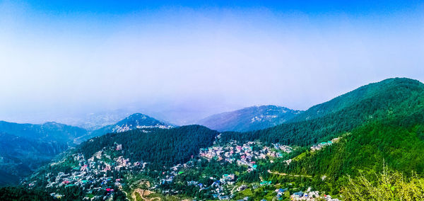 High angle view of townscape and mountains against sky