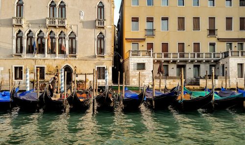 Boats in canal against buildings in city