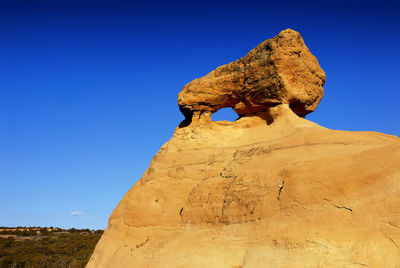 View of huge rocky structure against clear sky