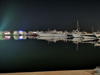 Sailboats in marina at night