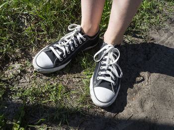 Low section of man standing on ground