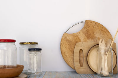 Close-up of glass jar on table against wall