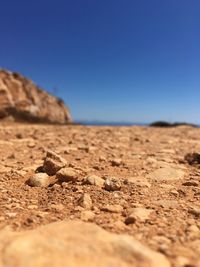 Surface level of sand against clear sky