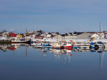 Boats moored at shore against sky
