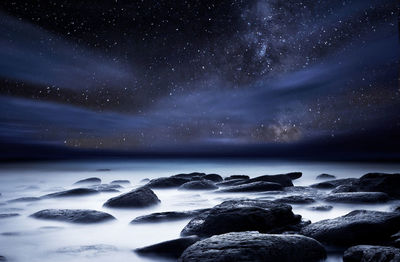 Scenic view of sea against sky at night