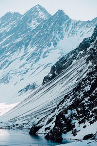 Snow-capped peaks tower over a pristine lake