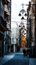 Street amidst buildings in city against sky