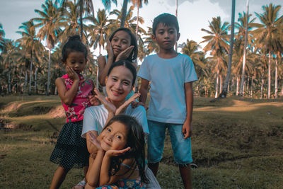 Portrait of happy kids sitting in park