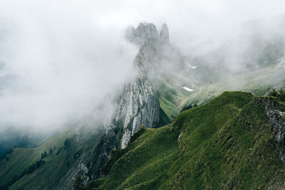 Scenic view of mountains against sky during foggy weather