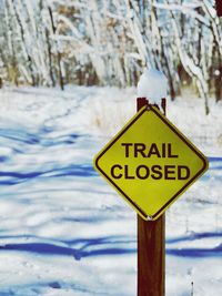 Close-up of warning sign on snow