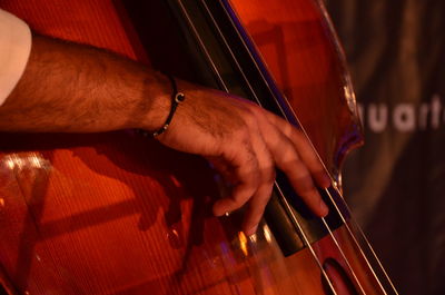 Cropped hand of man playing cello