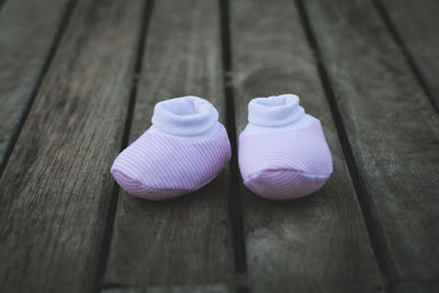 Close-up of baby booties on wooden table