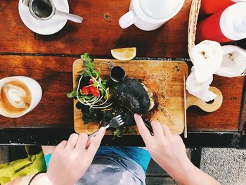 High angle view of hand holding drink on table