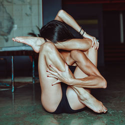 Midsection of woman sitting on floor