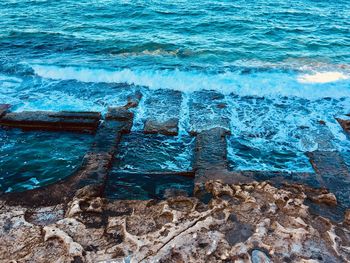 High angle view of rocks in sea