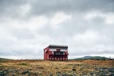 Built structure on field against sky