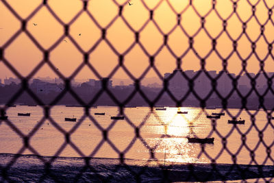 Full frame shot of chainlink fence during sunset