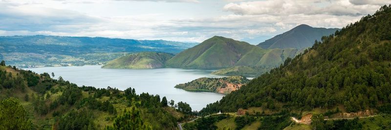 Panoramic view of trees and mountains against sky