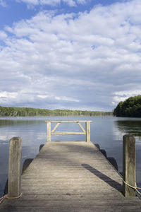 Pier over lake against sky