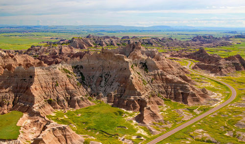 Aerial view of rock formations against cloudy sky