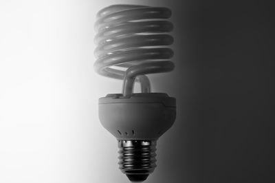 Close-up of light bulb against white background