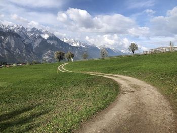 Scenic view of green landscape against sky