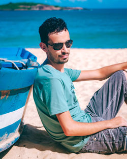 Young man sitting on beach