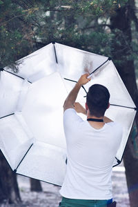 Rear view of man standing on white wall