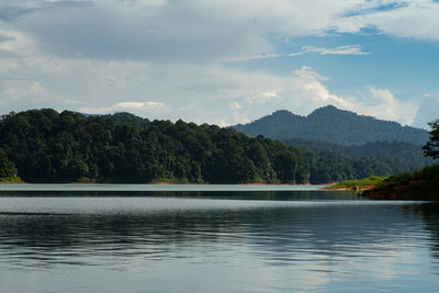 Scenic view of lake by trees against sky