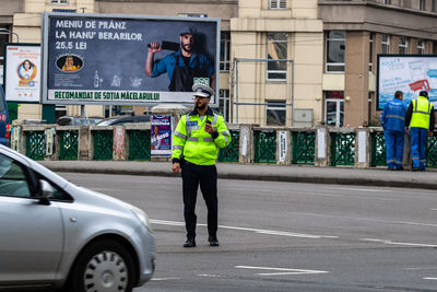 Full length of man standing on street in city