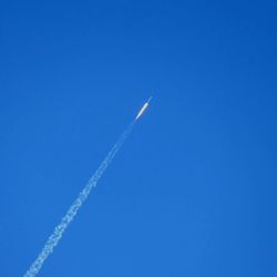 Low angle view of vapor trail against clear blue sky