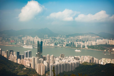 Panoramic view of city against cloudy sky