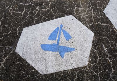 High angle view of arrow symbol on road