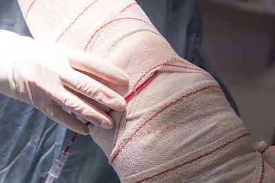 Cropped leg of person with bandage in hospital