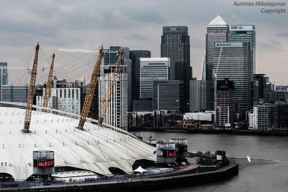 architecture, skyscraper, transportation, built structure, building exterior, city, nautical vessel, cloud - sky, river, outdoors, water, day, sky, urban skyline, no people, modern, cityscape